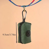 A dark olive green fabric poop bag dispenser attached to a metal carabiner clip.