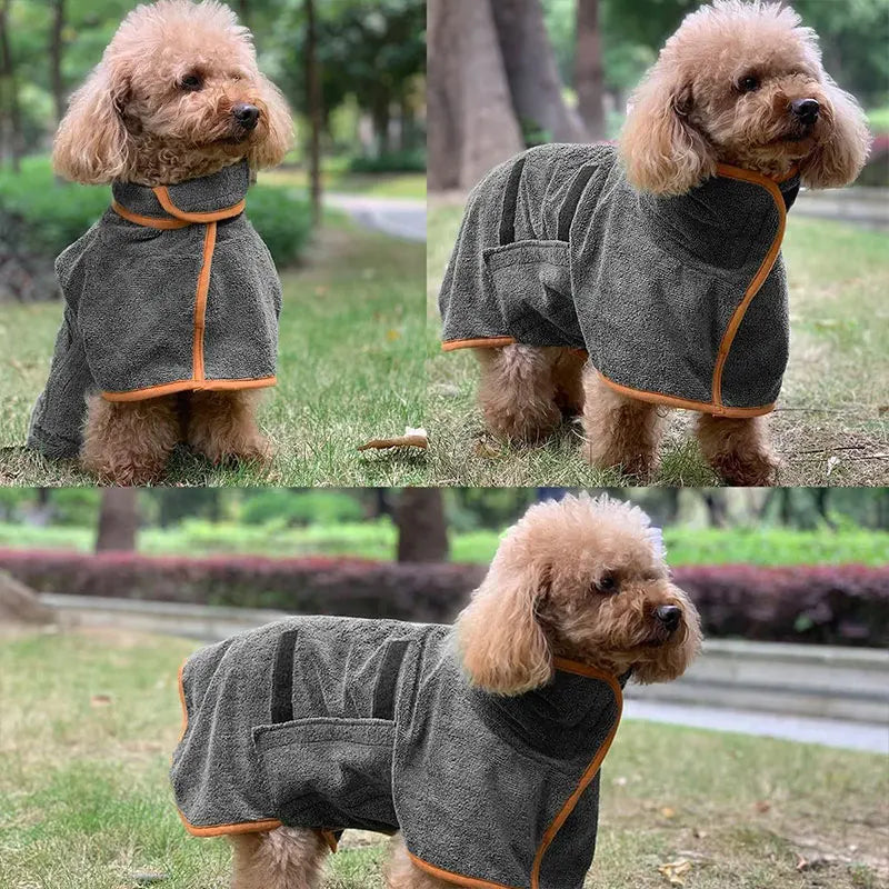 A fluffy light brown dog wearing a gray adjustable bathrobe outdoors.