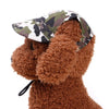 A brown, fluffy dog toy wearing a camouflage patterned visor cap.