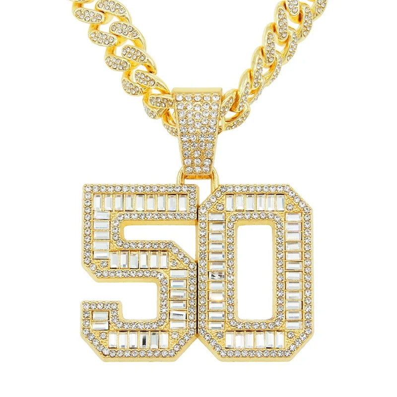 A gold iced out letter and animal pendant Cuban link chain necklace