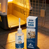 A bottle of EelJoy Pet Ear Cleaner solution next to a wire cage and a box labeled Pet Ear Cleaner.