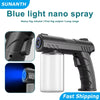 A black portable nano spray bottle for blue light fog, shown next to a clear glass bottle and a blue light effect.