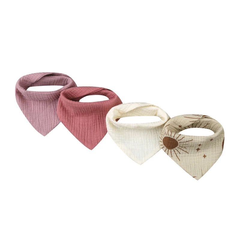 A set of four cotton baby bibs with various printed designs for newborns.