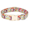 A beige nylon dog collar featuring a vibrant print of bees and flowers.