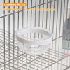 A clear glass bowl with a white rim is shown hanging in a metal wire grid.