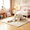 A white fluffy dog sits on a rug next to a pink wooden bed and a small pink table.