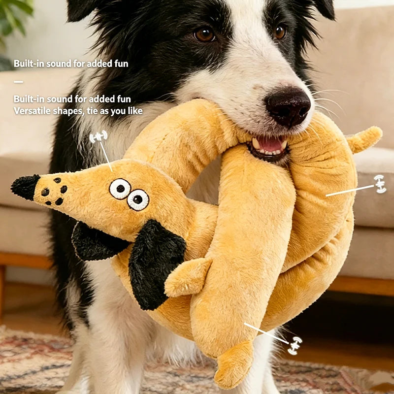 A dog holding a yellow squeaky plush toy shaped like a dachshund for play
