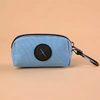Light blue fabric pouch with a black circular cross design and a black carabiner clip
