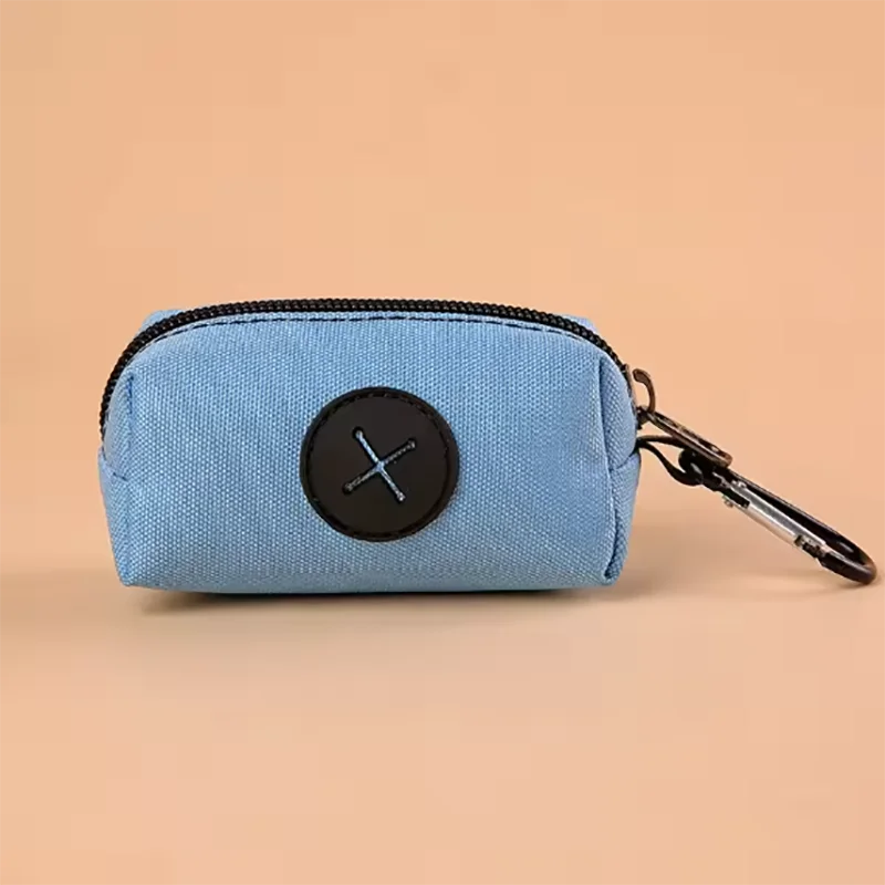 Light blue fabric pouch with a black circular cross design and a black carabiner clip