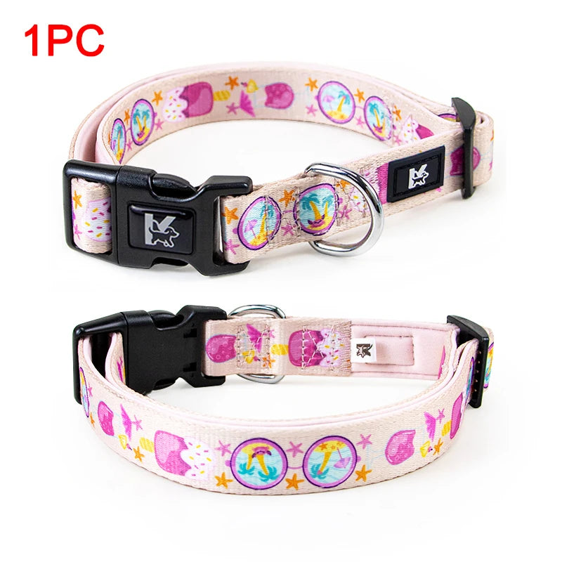 A pink and purple plaid polyester dog collar with a black buckle and silver ring.