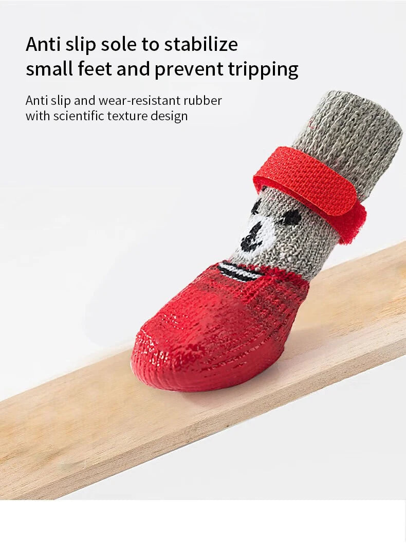 A pair of anti-slip rubber socks with a panda design placed on a wooden surface.