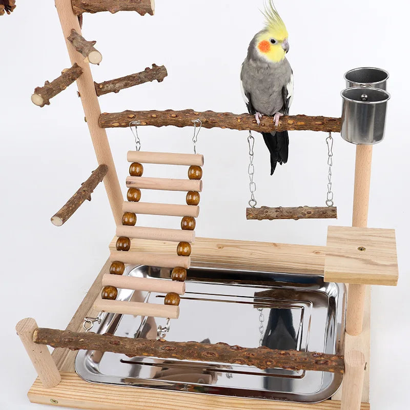 A wooden parrot climbing platform featuring branches, a perch, and a small yellow bird.