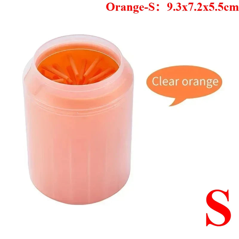 A pink portable paw washer cup with orange silicone bristles.