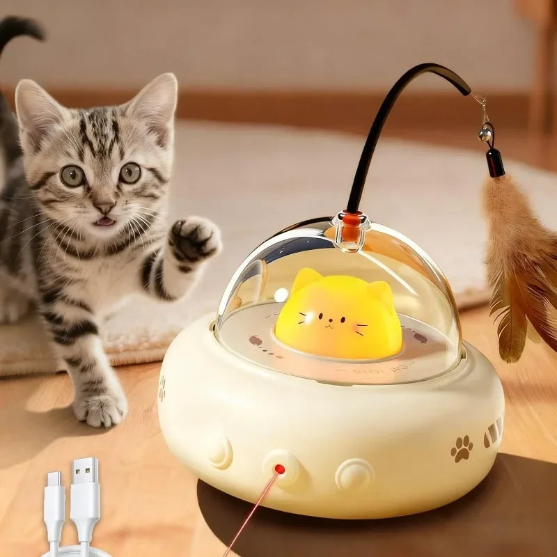A yellow interactive UFO cat teaser wand with feathers and a bell is shown next to a kitten.