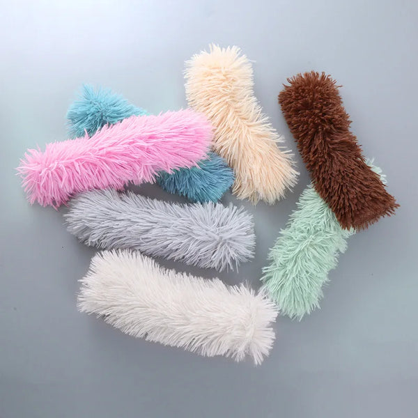 A collection of fluffy, elongated catnip-infused plush toys in various pastel and earthy colors.