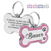 Silver and pink glitter pet ID tags with paw print designs and a custom name engraved on the tag