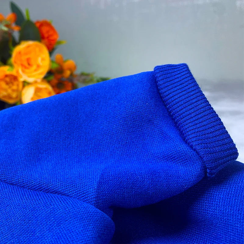 A close-up of a royal blue cotton dog hoodie sweatshirt fabric.