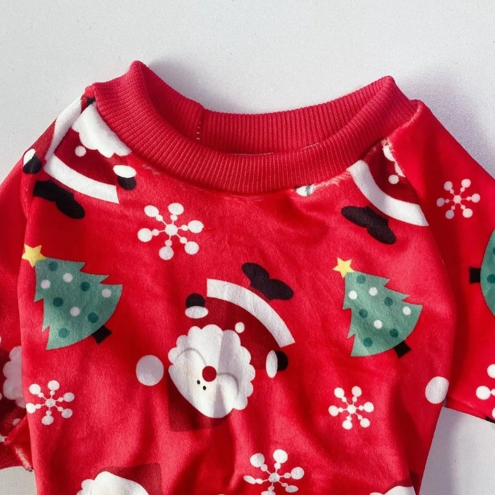 Red fleece dog pajamas featuring a white Santa Claus print with Christmas trees and snowflakes.