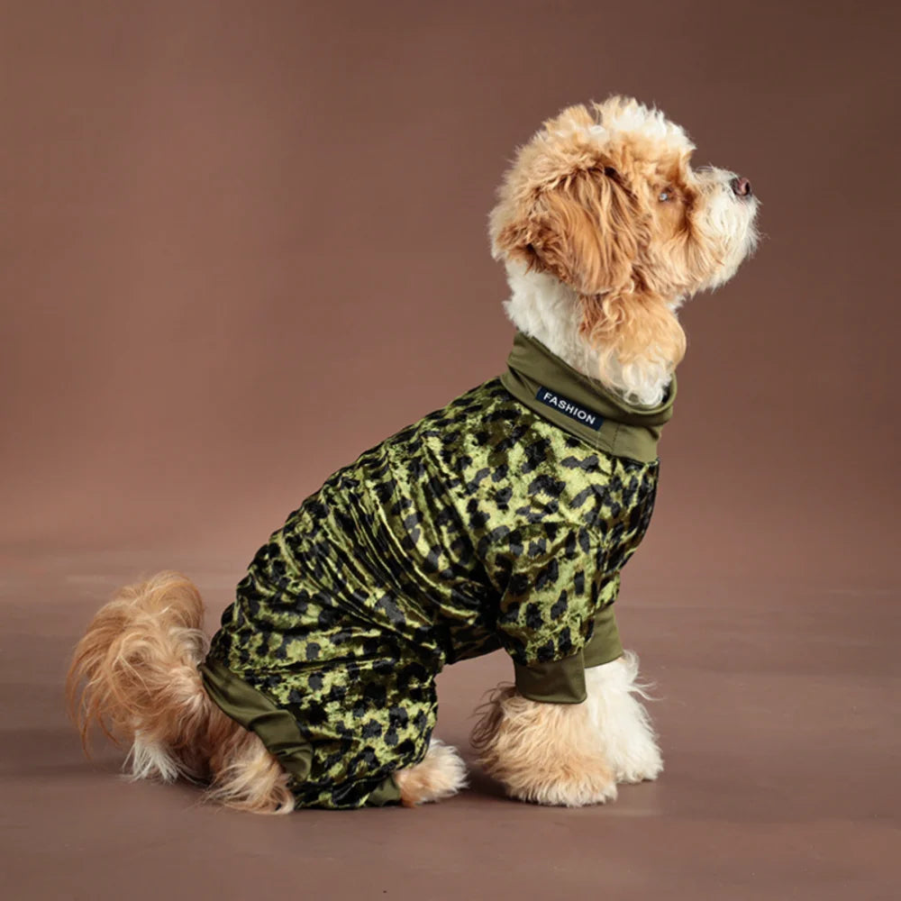 A light brown poodle wearing a green leopard print jumpsuit.