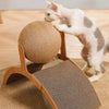 A white cat is interacting with a wooden scratching post and sisal scratching board for play.