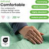 A hand is touching a green quilted fabric product, highlighting its soft and comfortable features.