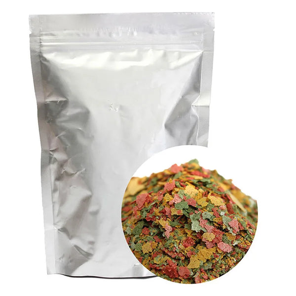 A white pouch of Tropical & Goldfish Fish Food with Spirulina next to a pile of colorful fish food.