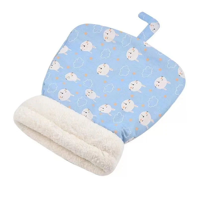 Light blue fabric cat bed with white cloud and cat patterns, lined with soft white fleece.