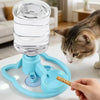 A blue gravity cat water dispenser with a bowl is shown next to a cat's paw.