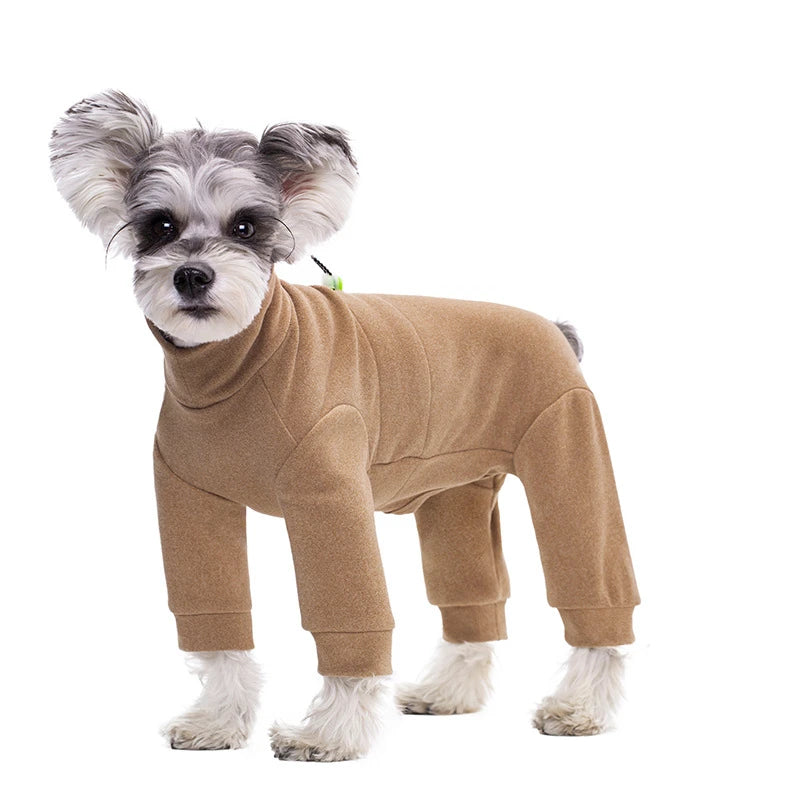 A small, fluffy dog wearing a tan thermal fleece jumpsuit.