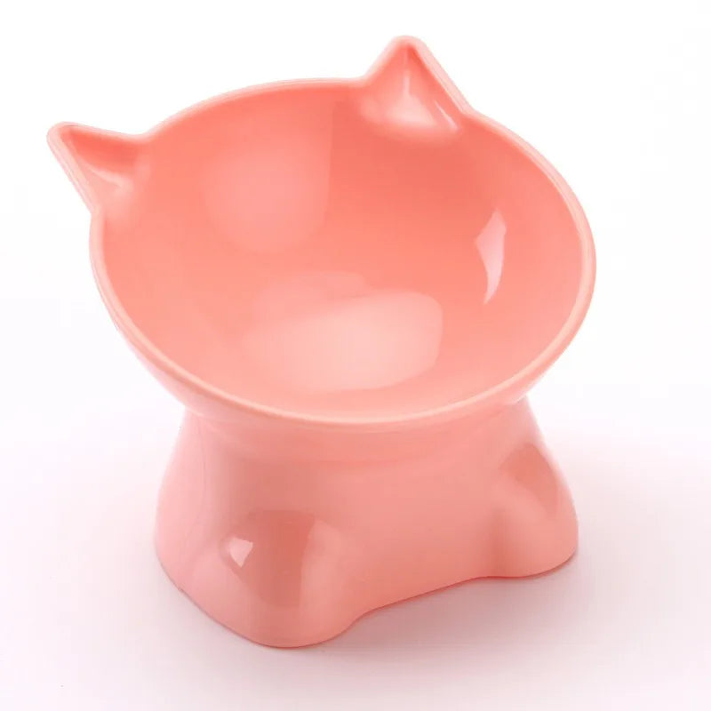 A pink ergonomic tilted cat feeding bowl with a smooth, glossy finish.
