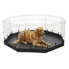 A light brown dog is resting inside a black wire mesh playpen with a mat.