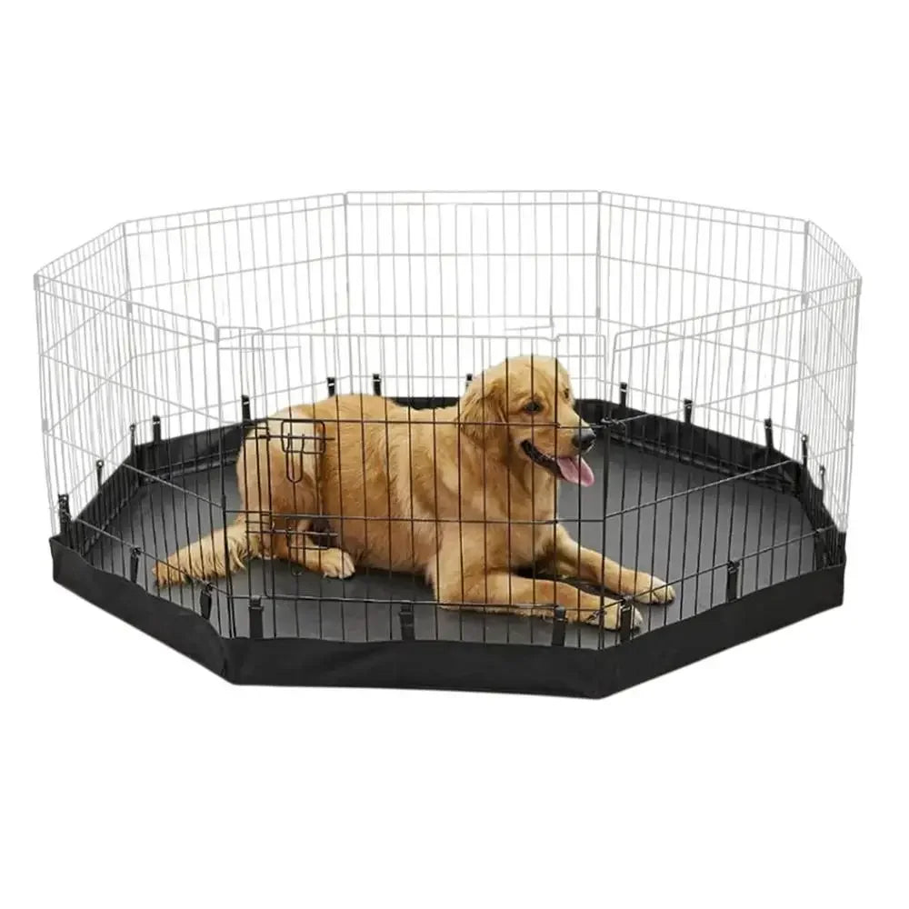 A light brown dog is resting inside a black wire mesh playpen with a mat.