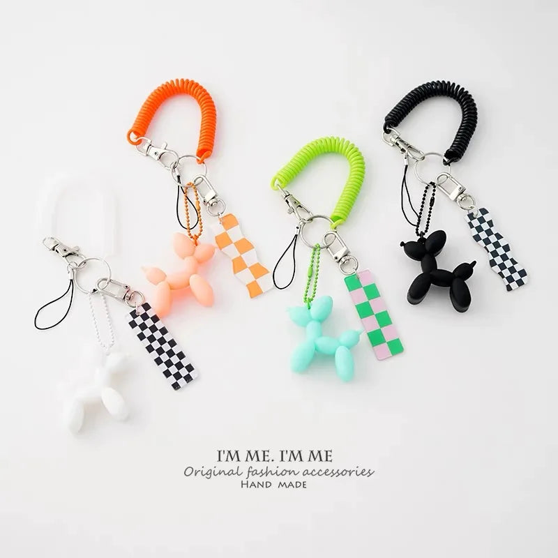 A collection of colorful acrylic balloon dog charm pendants in various colors and textures for jewelry making and keychains.