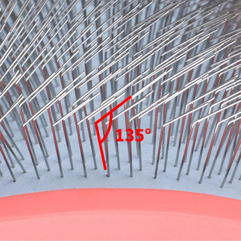 Close-up view of an ergonomic pet grooming rake with stainless steel teeth showing a 135 degree angle.