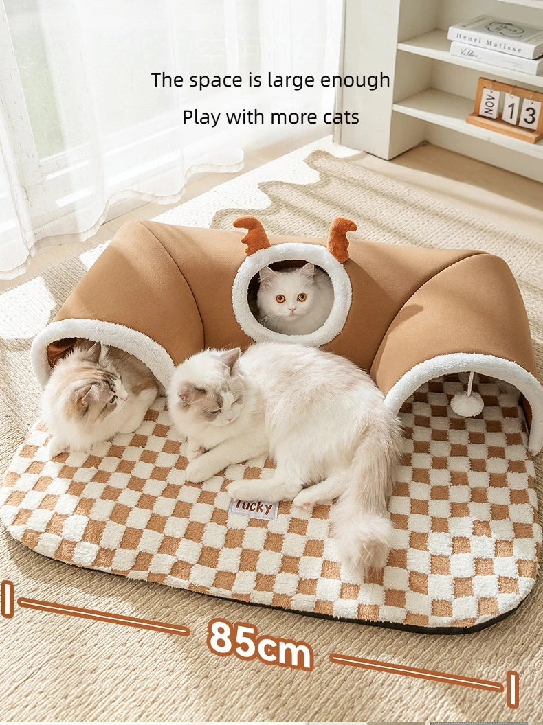 A brown plush cat bed with a reindeer tunnel is shown, featuring two cats inside.