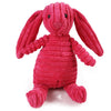 Jouet dentaire en forme de lapin rose vif et texturé pour mâcher.