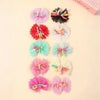 A collection of colorful lace dog hairbows featuring flowers and a butterfly.