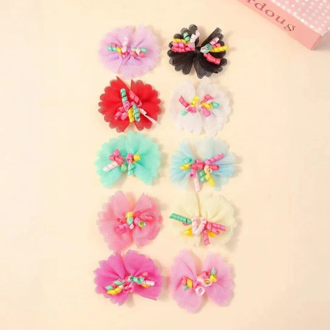 A collection of colorful lace dog hairbows featuring flowers and a butterfly.
