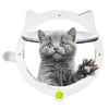 A fluffy gray kitten is looking out of a white, oval-shaped pet door with a clear viewing window.
