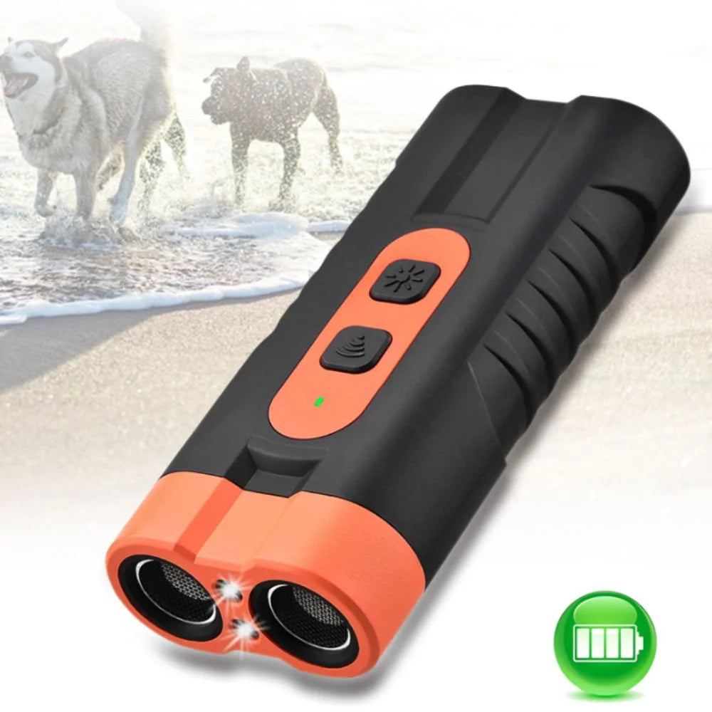 A black ultrasonic dog repeller device with an orange tip and a green battery icon, shown against a background of dogs near t