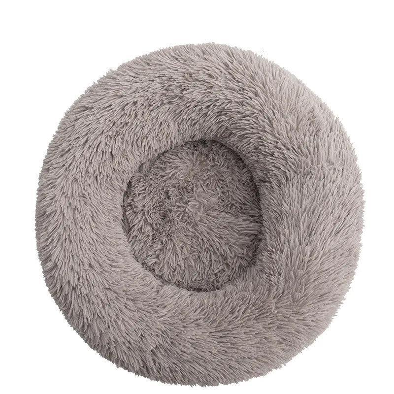 A round, plush pet bed with a textured gray anti-slip surface for dogs and cats.