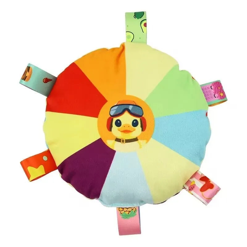 A plush dog toy shaped like a colorful flying disc with various colored segments and an eye design.