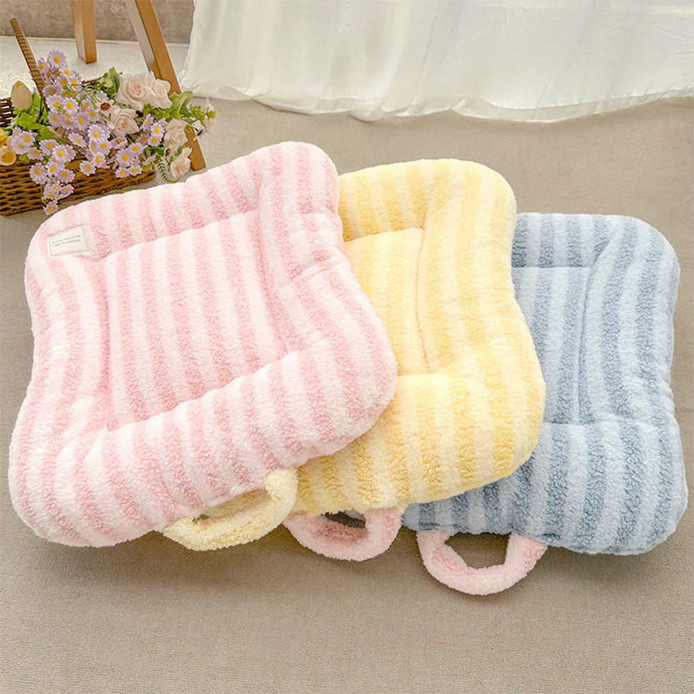 Three plush oval pet beds in pink, yellow, and blue striped fabric for cats and small dogs