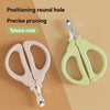 A pair of pink and yellow pet cat nail clippers with a safety guard shown on a wooden surface.