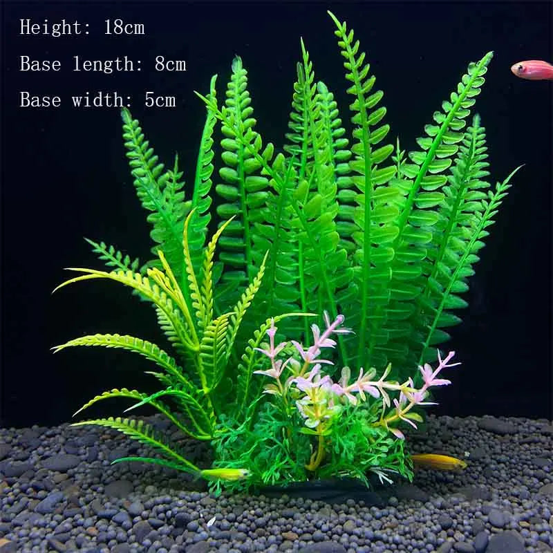 A vibrant green artificial aquarium plant with feathery leaves is rooted in dark gravel.