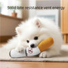 A fluffy white dog is playing with a solid bite resistance vent energy toy shaped like a cigar for dogs.