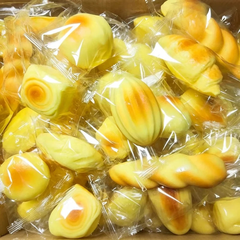 A collection of yellow squishy bread fidget toys packaged in clear plastic.