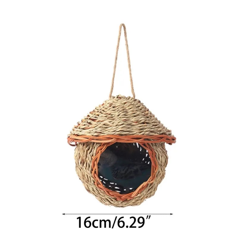 A natural grass hanging bird nest with an entrance, suspended by twine.