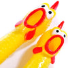 A bright yellow rubber chicken squeaky dog toy with red accents, shown in a close-up view.