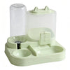 A light green gravity-fed pet food dispenser with a clear cylinder and a separate water bowl for cats and small dogs.